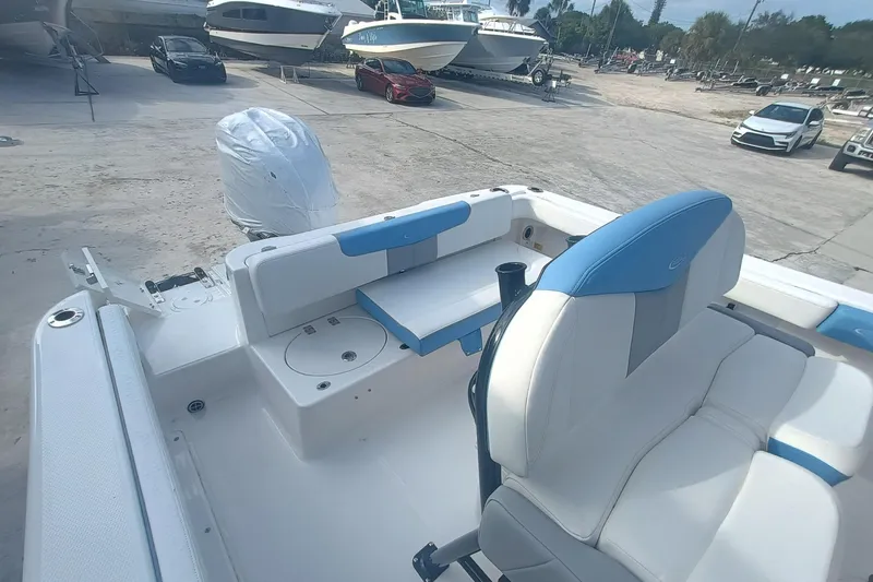 Slide: The Image of 2026 Robalo R222 Center Console boat interior with seating and engine view. - 12