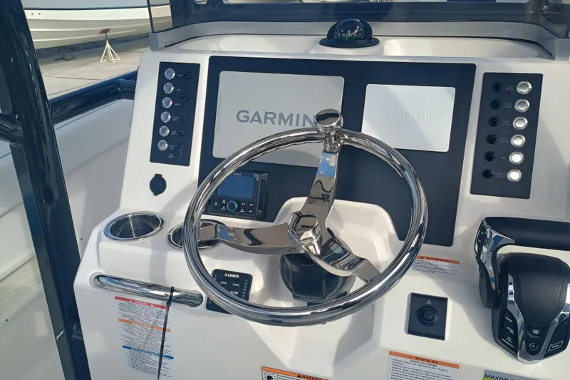 Slide: The Image of 2026 Robalo R222 Center Console boat dashboard with Garmin navigation system. - 14