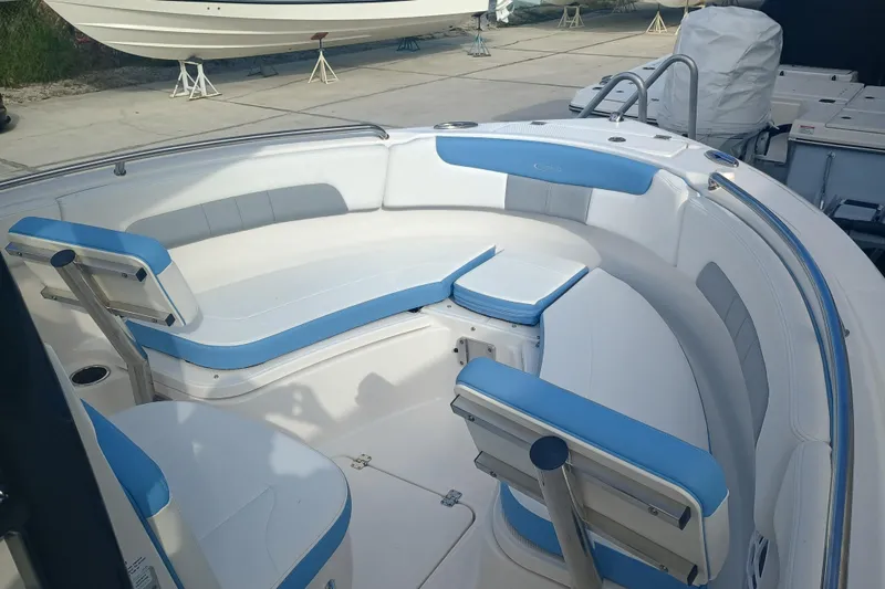 Slide: The Image of 2026 Robalo R222 Center Console boat interior with blue and white seating. - 16