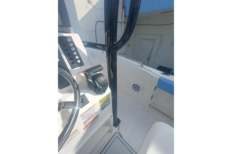 Slide: The Image of 2026 Robalo R222 Center Console boat interior with steering wheel and control panel. - 30