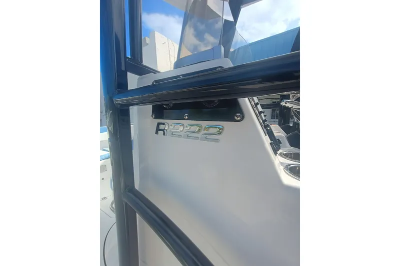 Slide: The Image of 2026 Robalo R222 Center Console boat, close-up of model emblem and console. - 32