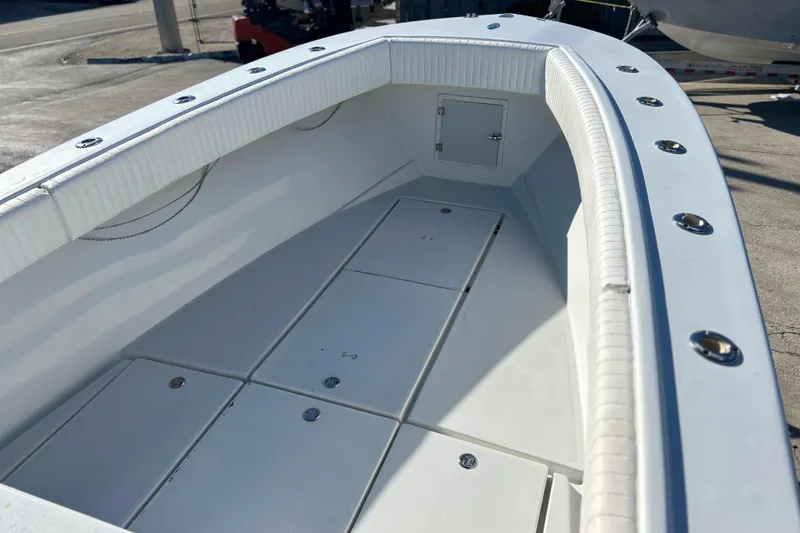 Slide: The Image of 1991 Contender 25 Open boat interior with storage compartments and sleek design. - 11