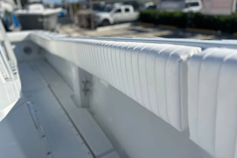Slide: The Image of Interior view of a 1991 Contender 25 Open boat, showcasing white padded railing. - 12
