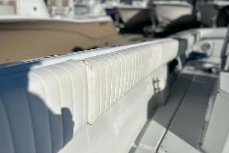 Slide: The Image of 1991 Contender 25 Open boat interior with white cushioned seating. - 13