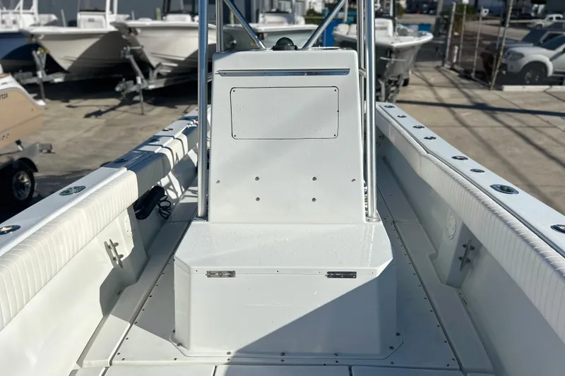 Slide: The Image of 1991 Contender 25 Open boat interior with white seating and console, docked outdoors. - 18
