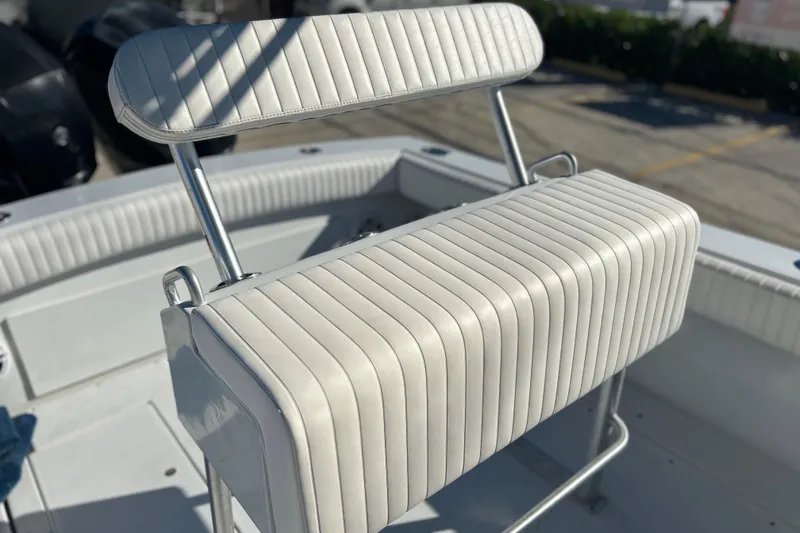 Slide: The Image of 1991 Contender 25 Open boat with white cushioned seating and stainless steel frame. - 19