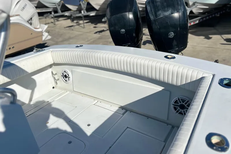 Slide: The Image of 1991 Contender 25 Open boat interior with cushioned seating and dual outboard motors. - 22