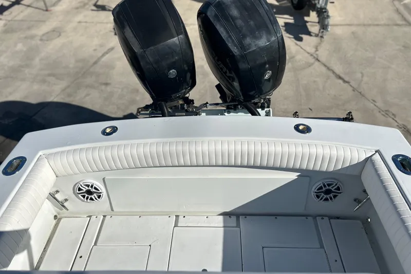 Slide: The Image of 1991 Contender 25 Open boat with dual outboard motors and white cushioned seating. - 23