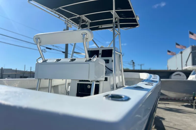 Slide: The Image of 1991 Contender 25 Open boat with T-top, docked under clear blue sky. - 24