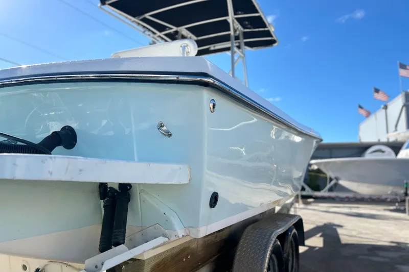 Slide: The Image of 1991 Contender 25 Open boat on trailer under clear blue sky. - 25