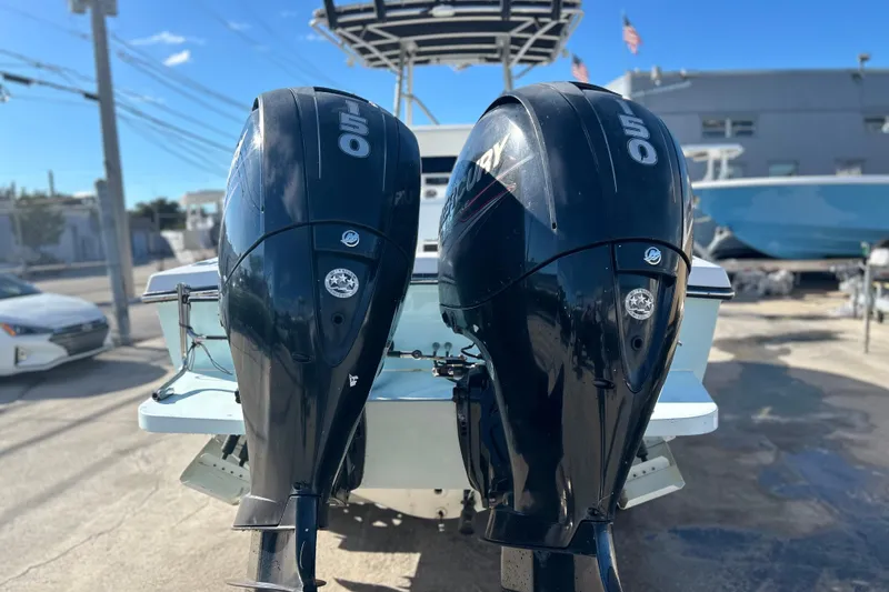 Slide: The Image of Twin Mercury 150 outboard engines on a 1991 Contender 25 Open boat. - 4