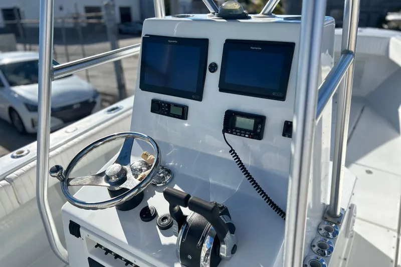 Slide: The Image of 1991 Contender 25 Open boat console with dual Raymarine displays and steering wheel. - 6