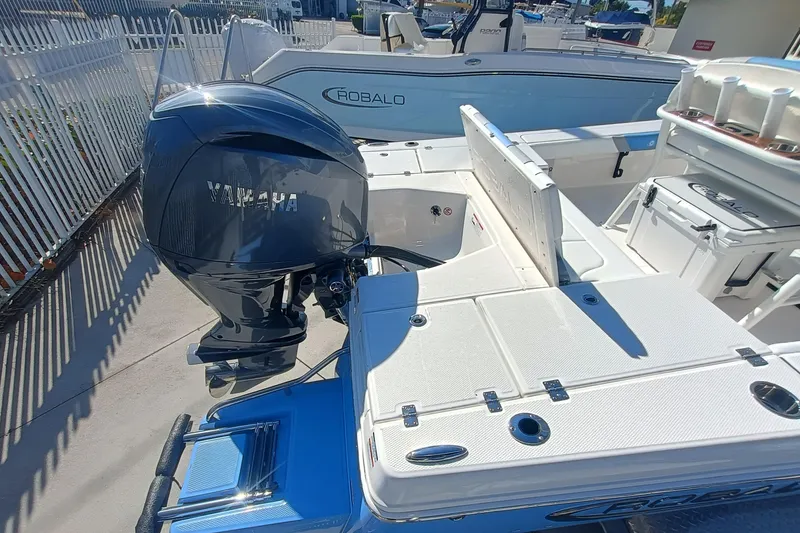 Slide: The Image of 2026 Robalo 226 Cayman boat with Yamaha outboard motor, docked in marina. - 23