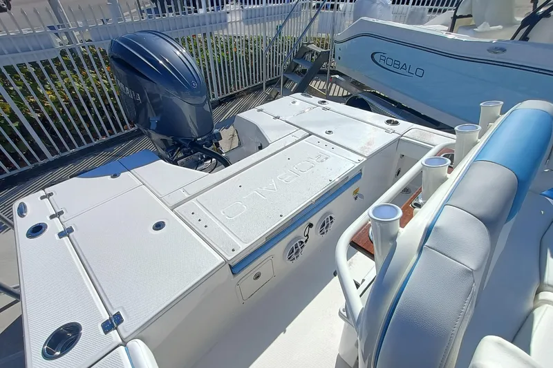 Slide: The Image of 2026 Robalo 226 Cayman boat with Yamaha outboard motor, white deck, and seating. - 24