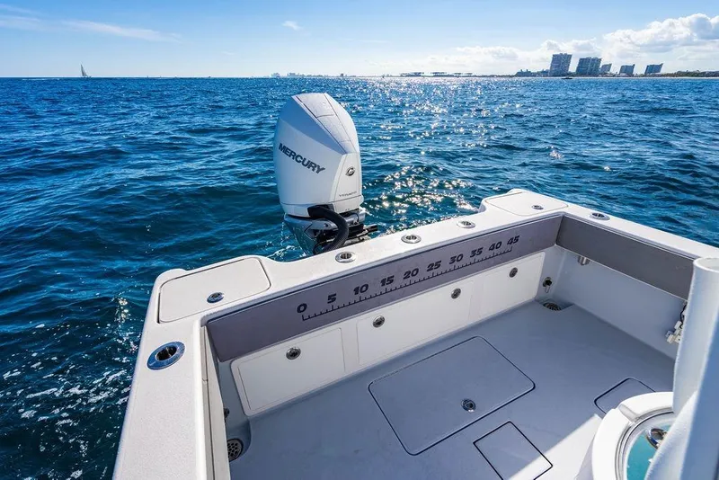 Slide: The Image of Reef Runner 230 boat 2026 on open sea under clear sky. - 32