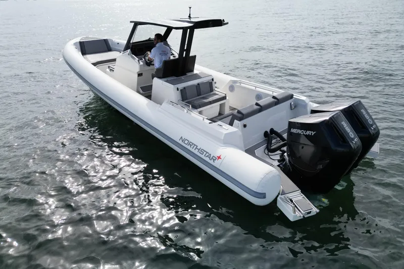 Slide: The Image of 2026 Northstar ORION 10 boat with dual Mercury engines on the water. - 12