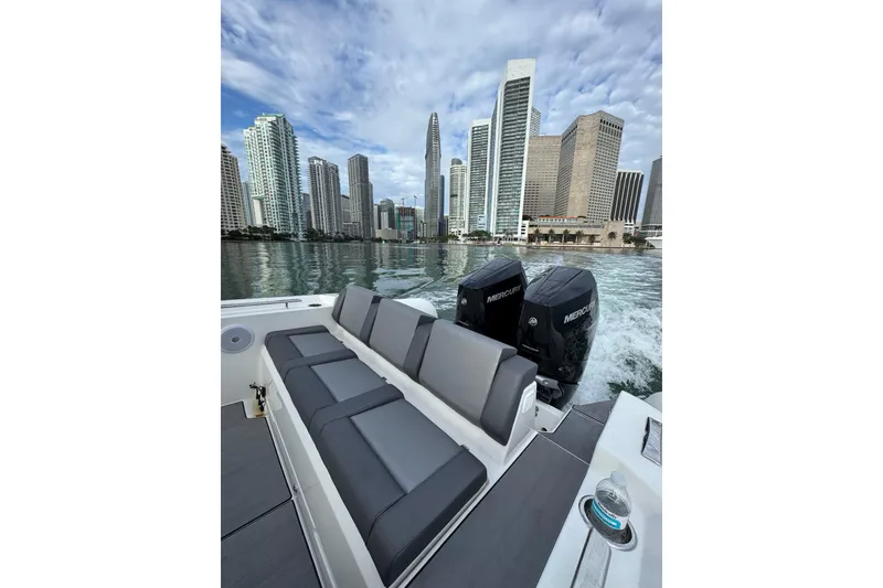 Slide: The Image of Northstar ORION 10 boat cruising near city skyline, 2026 model, with twin Mercury engines. - 21