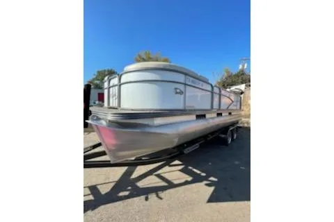 Slide: The Image of 2017 Manitou 22 Aurora LE Standard pontoon boat on trailer, sunny day. - 11