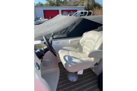 Slide: The Image of 2017 Manitou 22 Aurora LE Standard boat interior with captain's chair and steering wheel. - 4