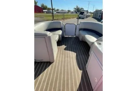 Slide: The Image of 2017 Manitou 22 Aurora LE Standard pontoon boat interior with seating and striped flooring. - 6