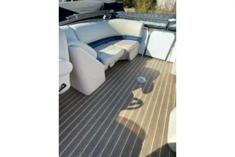 Slide: The Image of 2017 Manitou 22 Aurora LE Standard boat interior with striped flooring and cushioned seating. - 8