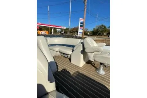 Slide: The Image of 2017 Manitou 22 Aurora LE Standard pontoon boat interior with beige seating. - 9