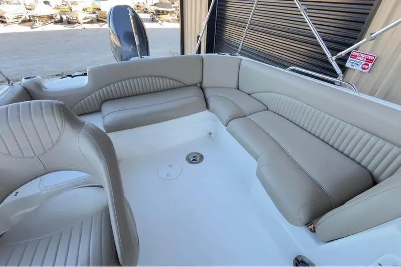 Slide: The Image of 2013 NauticStar 203 SC boat interior with beige seating and spacious layout. - 6