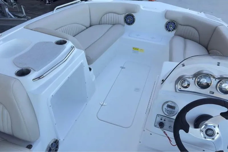 Slide: The Image of 2013 NauticStar 203 SC boat interior with beige seating and modern dashboard. - 7