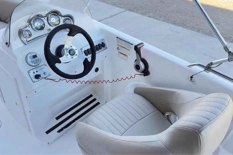 Slide: The Image of 2013 NauticStar 203 SC boat cockpit with steering wheel and gauges. - 9