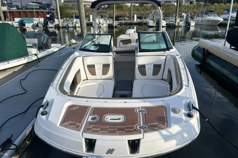 Slide: The Image of 2016 Four Winns HD270 OB boat docked at marina, featuring spacious seating and sleek design. - 1