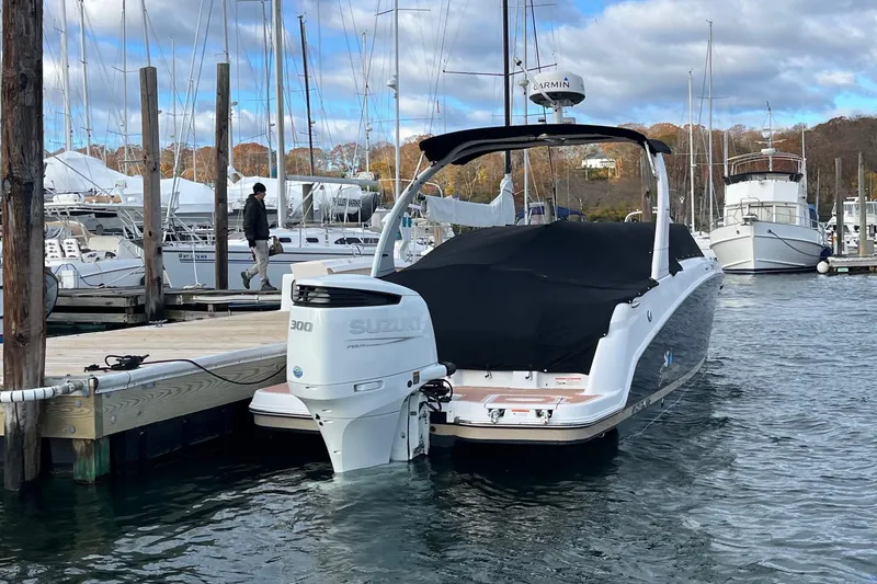Slide: The Image of 2016 Four Winns HD270 OB boat docked with Suzuki 300 outboard motor. - 12