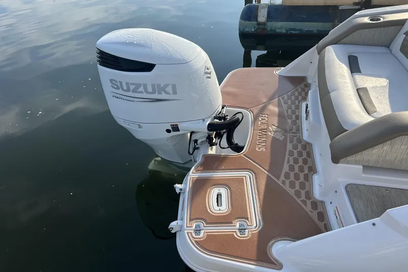 Slide: The Image of 2016 Four Winns HD270 OB boat with Suzuki outboard motor on calm water. - 4