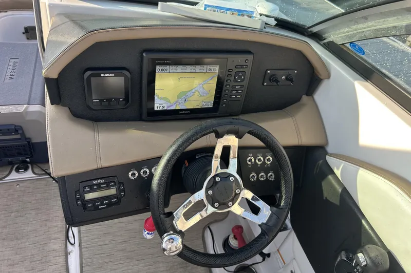 Slide: The Image of 2016 Four Winns HD270 OB boat dashboard with Garmin navigation system and steering wheel. - 5