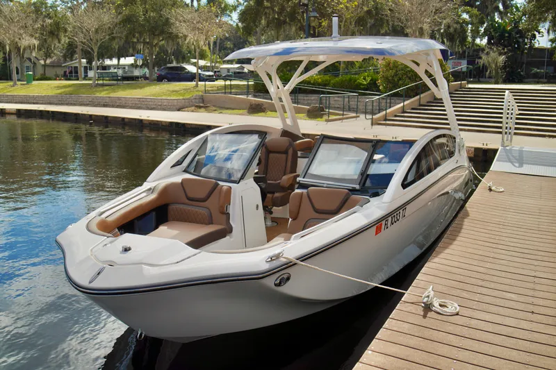 Slide: The Image of 2025 Yamaha Boats 275SD docked, showcasing sleek design and luxurious seating. - 10