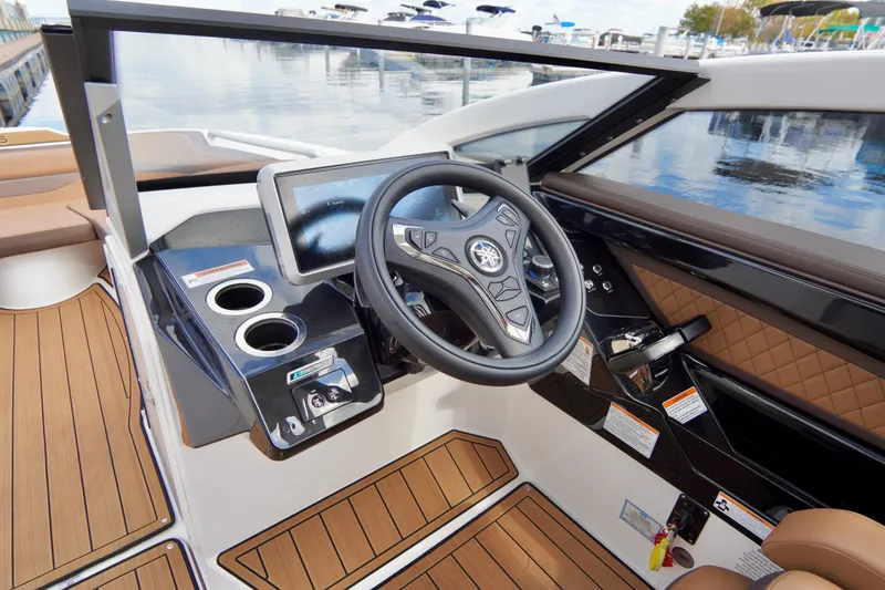 Slide: The Image of 2025 Yamaha Boats 275SD helm with modern steering and touchscreen display. - 16