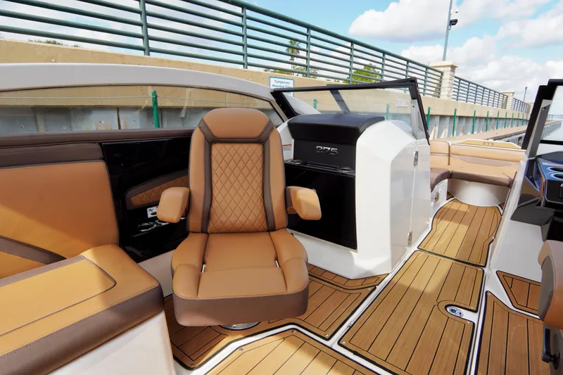 Slide: The Image of 2025 Yamaha Boats 275SD interior with luxurious tan seating and sleek design. - 18