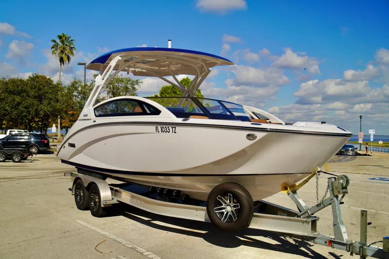 Slide: The Image of 2025 Yamaha Boats 275SD on trailer under blue sky. - 2