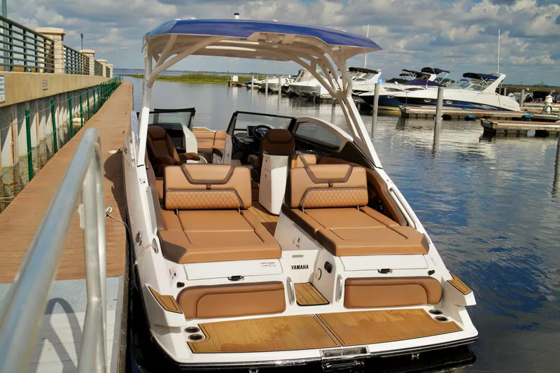 Slide: The Image of 2025 Yamaha Boats 275SD docked, featuring luxurious seating and sleek design. - 27