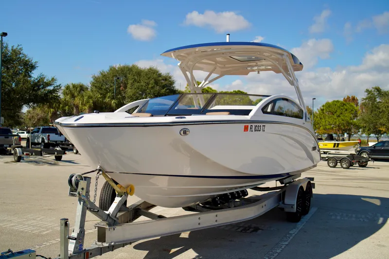 Slide: The Image of 2025 Yamaha Boats 275SD on trailer in sunny parking lot. - 6