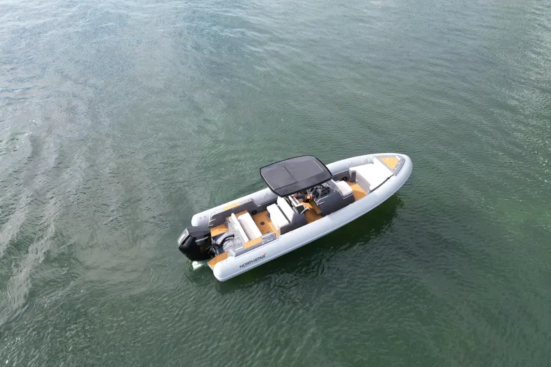 Slide: The Image of 2026 Northstar Orion 8 boat on calm water, featuring sleek design and modern amenities. - 2