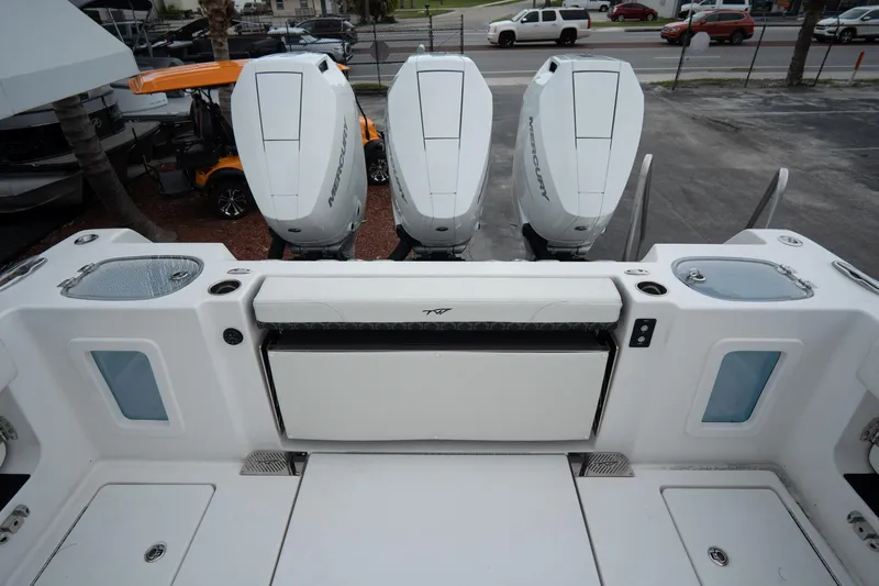 Slide: The Image of Overhead view of 2023 Tidewater 380 CC Adventure boat docked at marina. - 11