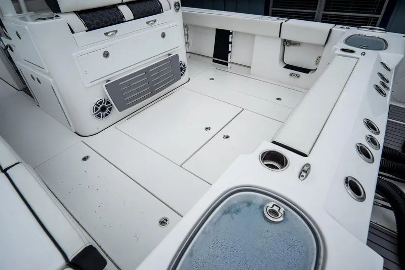 Slide: The Image of 2023 Tidewater 380 CC Adventure boat docked with triple Mercury engines. - 13