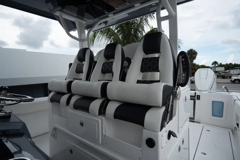 Slide: The Image of 2023 Tidewater 380 CC Adventure boat interior with luxurious seating and modern design. - 17