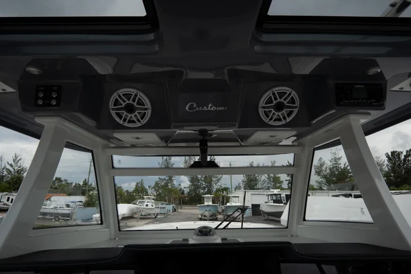 Slide: The Image of 2023 Tidewater 380 CC Adventure boat interior with storage and speaker details. - 18