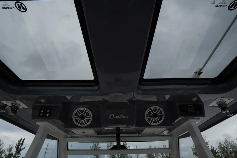 Slide: The Image of 2023 Tidewater 380 CC Adventure boat interior with fold-out table and cushioned seating. - 19