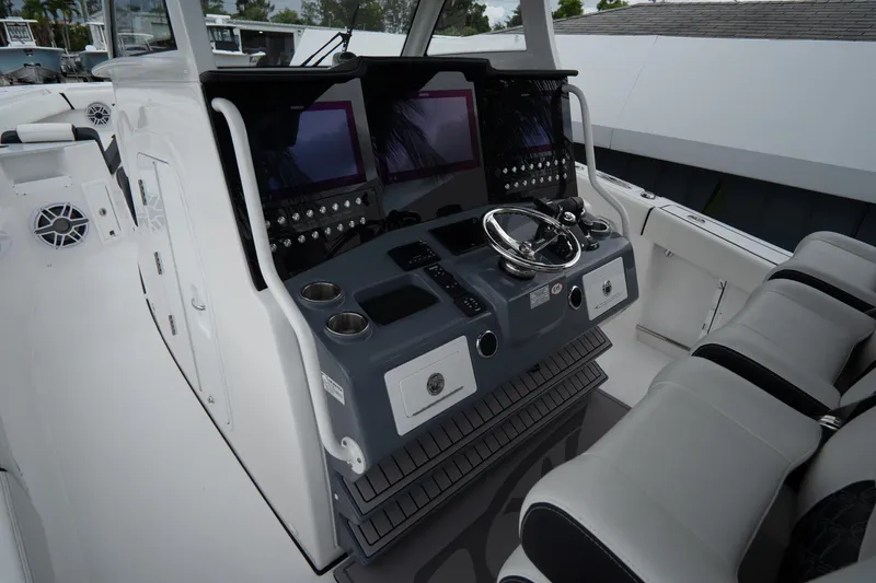Slide: The Image of 2023 Tidewater 380 CC Adventure boat storage compartments with drawers and tackle boxes. - 20