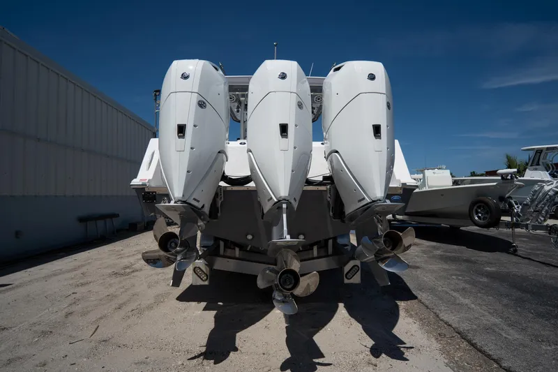 Slide: The Image of Aerial view of 2023 Tidewater 380 CC Adventure boat docked by a lush waterfront. - 3