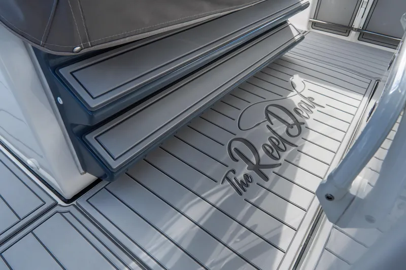 Slide: The Image of 2023 Tidewater 380 CC Adventure boat deck with rod holders and speakers. - 30