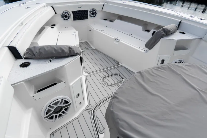 Slide: The Image of 2023 Tidewater 380 CC Adventure boat deck with storage compartments and logo. - 31