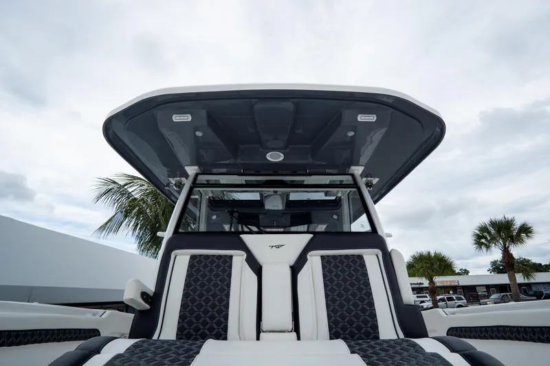 Slide: The Image of 2023 Tidewater 380 CC Adventure boat deck with Yeti cooler and outboard motors. - 38